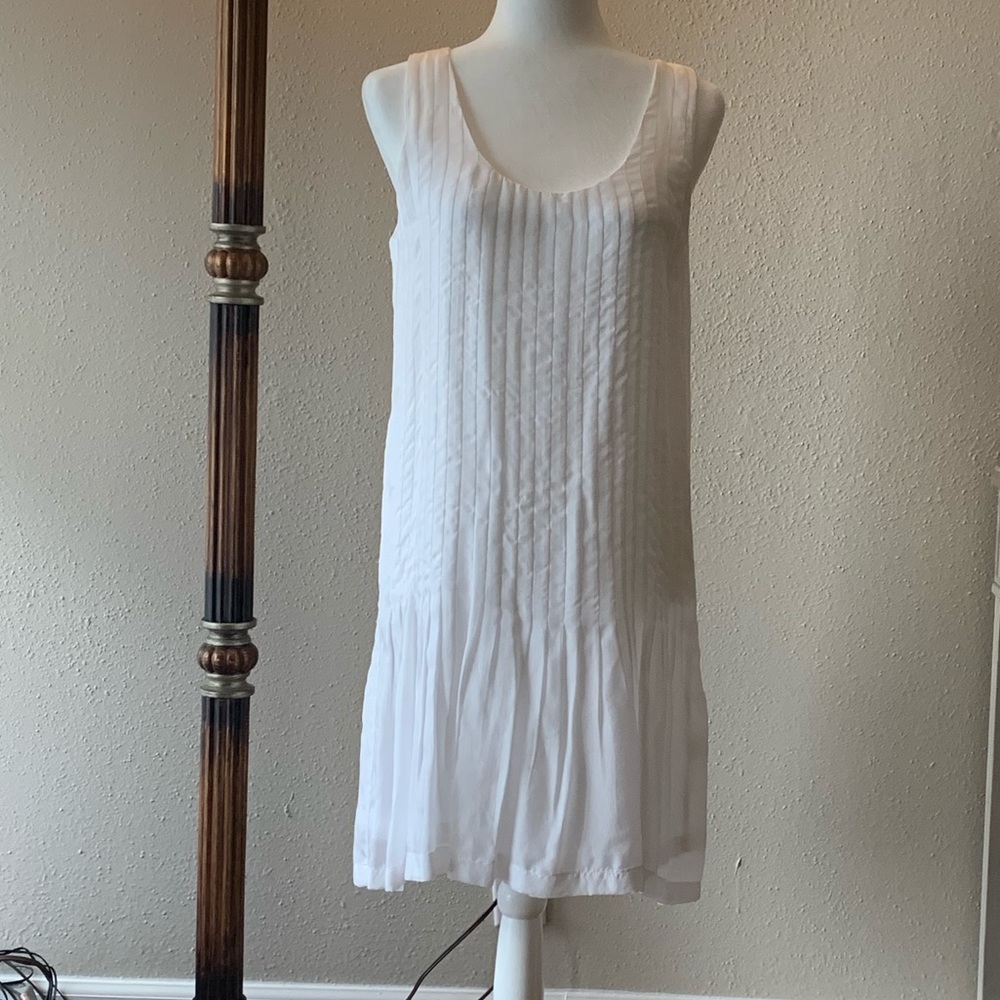 White loose fitting bodice with flared skit dress